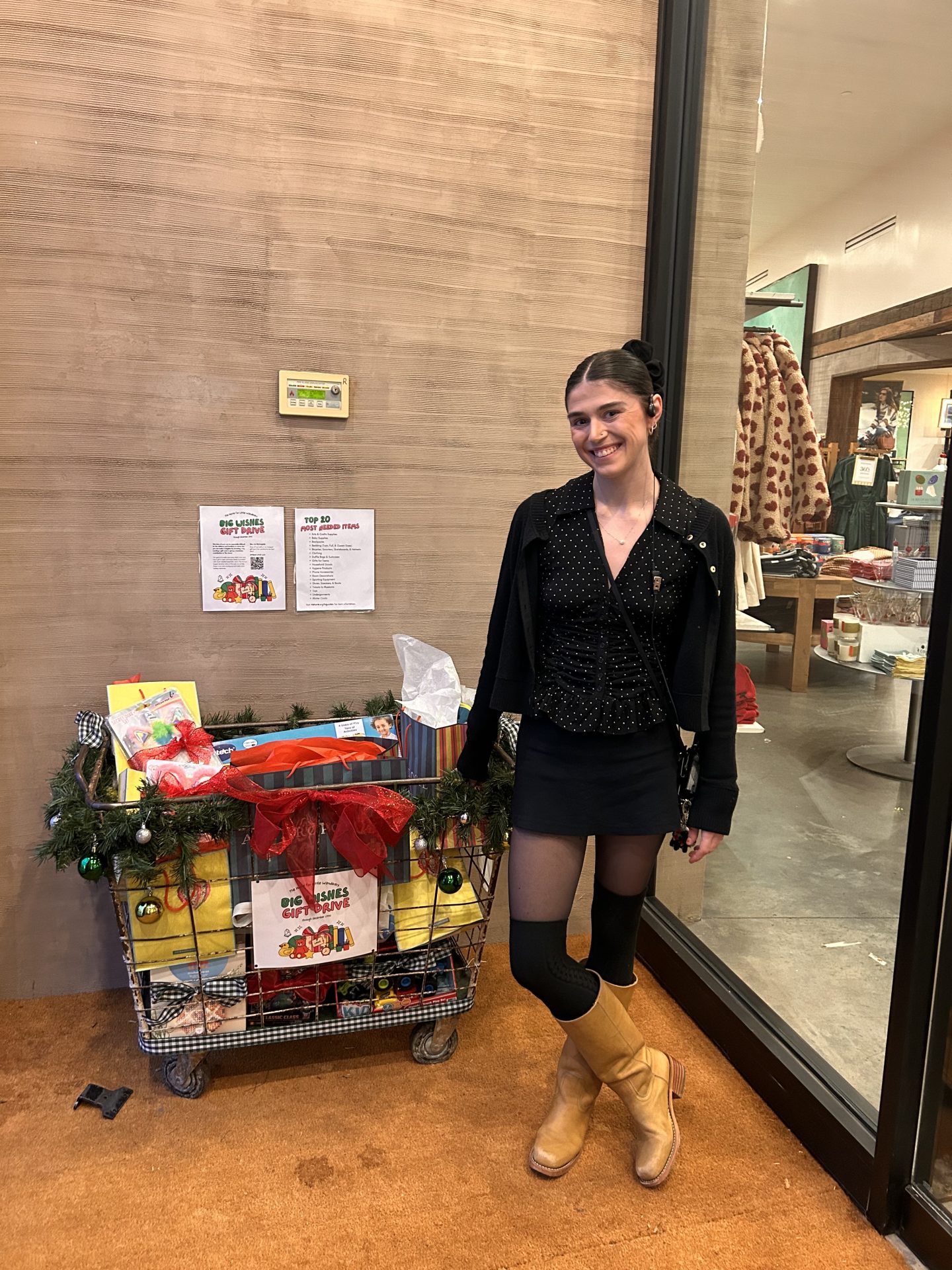 Megan Farretta stands with gift collection box at Anthropologie during the holiday season