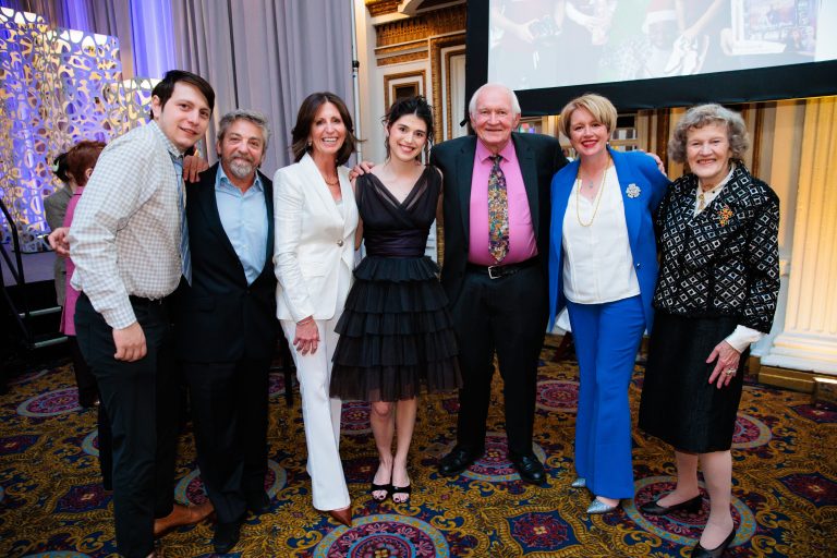 Megan at Voices & Visions, with her family and President and CEO of The Home Lesli Suggs