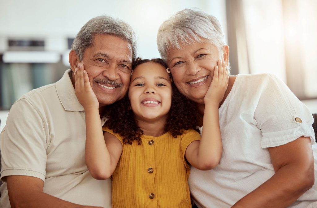young girl between her grandparents