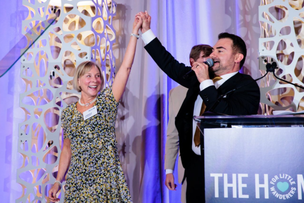 Emcee and auctioneer Chuck Dukas congratulates the winner of the Heads and Tails game