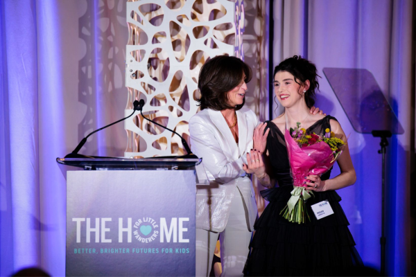 Lesli Suggs presents Megan Farretta with flowers onstage
